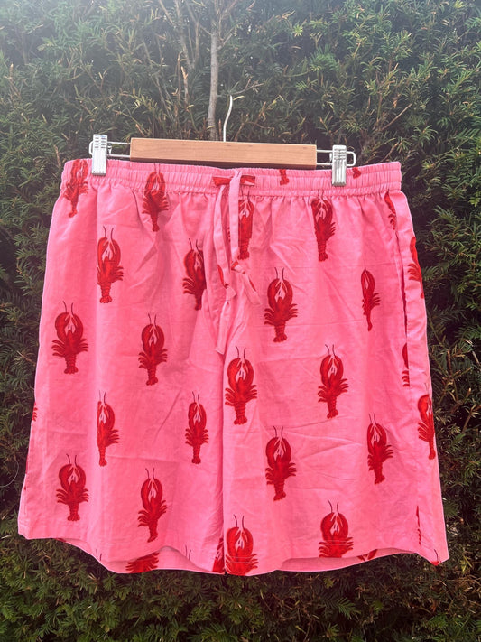 Wild Lotus UK men's pink cotton sleep shorts with a red lobster print, elasticated drawstring waist, and side pockets.