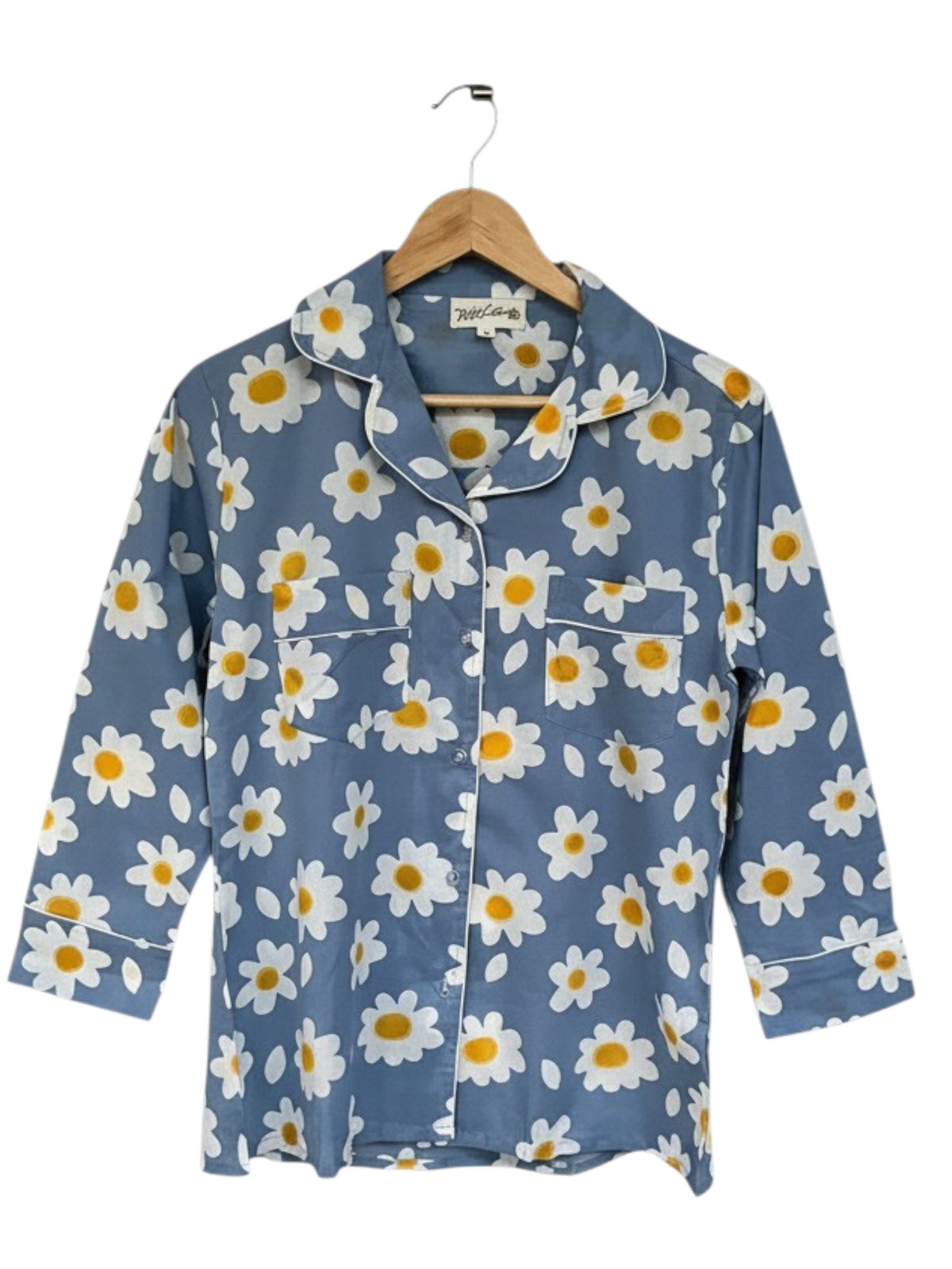 Wild Lotus UK blue cotton pyjama top with white daisy print, revere collar, chest pocket, and white piping detail.