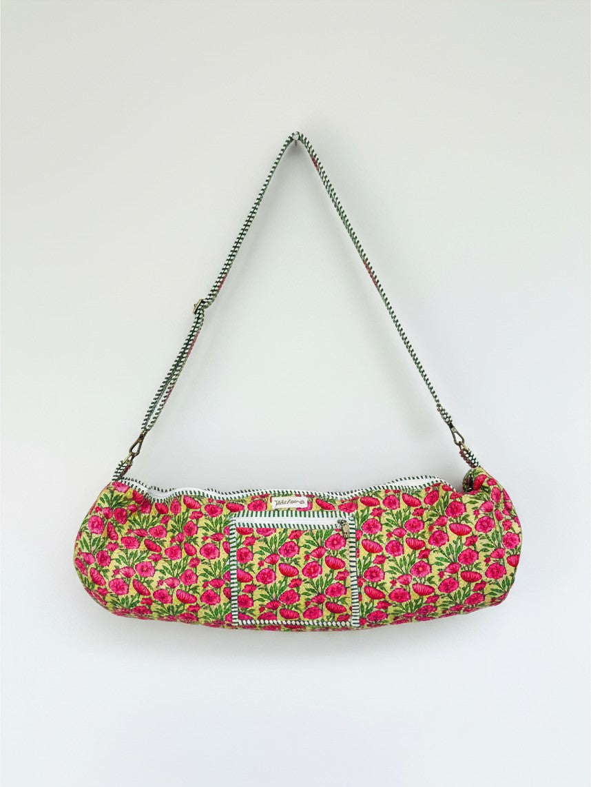 Wild Lotus UK quilted cotton yoga mat bag in floral print with green and white striped trim and adjustable strap.