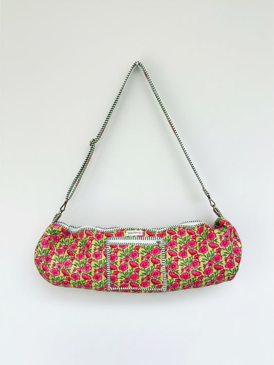 Wild Lotus UK quilted cotton yoga mat bag in floral print with green and white striped trim and adjustable strap.