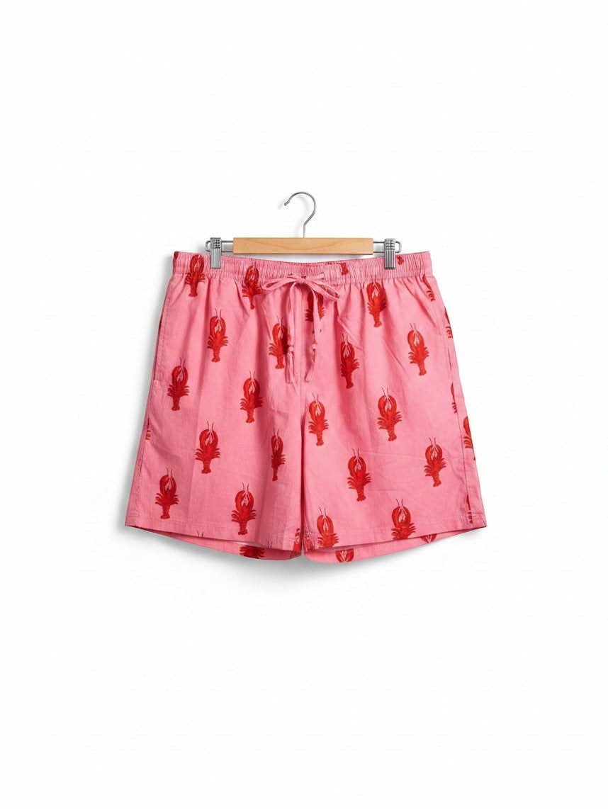 Wild Lotus UK men's pink cotton sleep shorts featuring a red lobster print, elasticated drawstring waist, and pockets.